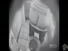 With her trousers down, a sultry wife quickly masturbates in the restroom.